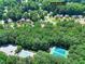Aerial view shows a community with pool, tennis courts, and mature trees at 1935 Shrader Ct, Lawrenceville, GA 30044