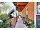 Long porch with brick columns and lush landscaping at 1935 Shrader Ct, Lawrenceville, GA 30044