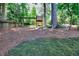 Large backyard with a play set and mature trees offering ample shade at 1935 Shrader Ct, Lawrenceville, GA 30044