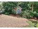 Quaint backyard shed surrounded by lush greenery, nestled in a serene, wooded setting at 1935 Shrader Ct, Lawrenceville, GA 30044