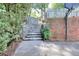 Outdoor space featuring stone stairs with a brick wall and a basketball hoop at 1935 Shrader Ct, Lawrenceville, GA 30044