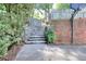 Outdoor basketball court featuring brick wall, stone steps and fence in a landscaped backyard at 1935 Shrader Ct, Lawrenceville, GA 30044