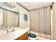 Traditional bathroom with a single vanity, shower, and neutral checkered wallpaper at 1935 Shrader Ct, Lawrenceville, GA 30044