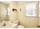 Bathroom showcasing patterned wallpaper, a white vanity, and a decorative mirror at 1935 Shrader Ct, Lawrenceville, GA 30044