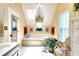 Bright bathroom with a soaking tub under a skylight, complemented by plants at 1935 Shrader Ct, Lawrenceville, GA 30044