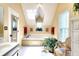 Bright bathroom with a soaking tub, skylight, vanity, and a large window at 1935 Shrader Ct, Lawrenceville, GA 30044