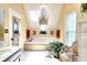 Bright bathroom with a soaking tub under a skylight, complemented by neutral tones and a vanity area at 1935 Shrader Ct, Lawrenceville, GA 30044
