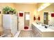 Bright bathroom with double vanity, a bath tub, and a walk-in shower at 1935 Shrader Ct, Lawrenceville, GA 30044