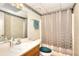 Bathroom featuring a shower with a curtain, vanity, toilet with a green seat, and patterned wallpaper at 1935 Shrader Ct, Lawrenceville, GA 30044