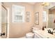 Bathroom featuring a shower, window with blinds, vanity with mirror, and a toilet at 1935 Shrader Ct, Lawrenceville, GA 30044