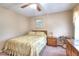 Cozy bedroom with floral bedding, ceiling fan and natural light creating a warm and inviting atmosphere at 1935 Shrader Ct, Lawrenceville, GA 30044