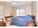 Bedroom with a dark wood bed frame and desk near a window with natural light at 1935 Shrader Ct, Lawrenceville, GA 30044