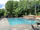 A community pool with lots of lounge chairs and a playground in the background at 1935 Shrader Ct, Lawrenceville, GA 30044
