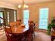 Formal dining room boasts a beautiful wooden table and natural light from large windows at 1935 Shrader Ct, Lawrenceville, GA 30044