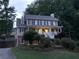 Charming two-story home boasts a welcoming front porch, manicured landscaping, and a driveway at 1935 Shrader Ct, Lawrenceville, GA 30044