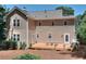Back exterior view of home with a wood deck and lawn at 1935 Shrader Ct, Lawrenceville, GA 30044