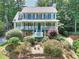 Inviting two-story home with a charming front porch and beautifully landscaped front yard at 1935 Shrader Ct, Lawrenceville, GA 30044