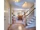 Inviting foyer with hardwood floors, staircase, and view into the dining room at 1935 Shrader Ct, Lawrenceville, GA 30044