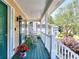 Cozy covered porch area with a small table and chairs and painted green flooring at 1935 Shrader Ct, Lawrenceville, GA 30044