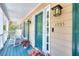 Inviting front porch with rocking chairs, wood flooring, a blue door and matching shutters at 1935 Shrader Ct, Lawrenceville, GA 30044