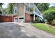 A two-car garage and driveway of a two-story house with brick and vinyl siding at 1935 Shrader Ct, Lawrenceville, GA 30044