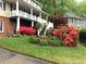Well manicured landscape with green grass and colorful flowering bushes at 1935 Shrader Ct, Lawrenceville, GA 30044