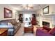 Bright living room with fireplace, neutral tones, and french doors leading to office at 1935 Shrader Ct, Lawrenceville, GA 30044