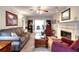 Spacious living room features a fireplace, a ceiling fan, comfortable seating, and French doors at 1935 Shrader Ct, Lawrenceville, GA 30044