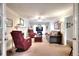 Spacious living area with a fireplace, plush seating, and ample lighting at 1935 Shrader Ct, Lawrenceville, GA 30044