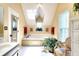 Bright Primary bathroom with a tub, a large window, and plant at 1935 Shrader Ct, Lawrenceville, GA 30044