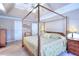 Serene main bedroom featuring a four-poster bed, tray ceiling, and neutral decor for a relaxing retreat at 1935 Shrader Ct, Lawrenceville, GA 30044