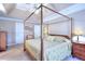 Spacious main bedroom featuring a four-poster bed, neutral walls, and carpet at 1935 Shrader Ct, Lawrenceville, GA 30044