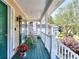 Inviting front porch with green trim, a seating area, and a view of the surrounding neighborhood at 1935 Shrader Ct, Lawrenceville, GA 30044
