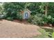 View of a small shed surrounded by a lush, wooded backyard at 1935 Shrader Ct, Lawrenceville, GA 30044