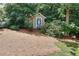 Storage shed nestled in a wooded backyard providing ample space for outdoor equipment at 1935 Shrader Ct, Lawrenceville, GA 30044