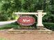 Entrance sign for Flowers Crossing community featuring flowering plants at 1935 Shrader Ct, Lawrenceville, GA 30044