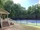 Community tennis courts offering a recreational space for residents, adjacent to a covered viewing area at 1935 Shrader Ct, Lawrenceville, GA 30044