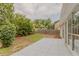 The backyard features a concrete patio, green grass, trees, and a wood fence at 4565 English Oaks Ln, Lilburn, GA 30047