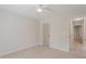 Well-lit carpeted bedroom features a ceiling fan and neutral colored paint at 4565 English Oaks Ln, Lilburn, GA 30047