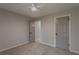 Well-lit carpeted bedroom features a ceiling fan and two access doors at 4565 English Oaks Ln, Lilburn, GA 30047