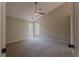 Spacious carpeted bedroom with natural light from two windows and a ceiling fan at 4565 English Oaks Ln, Lilburn, GA 30047