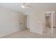 Bright bedroom features neutral carpet, ceiling fan, closet and leads to the tiled hallway at 4565 English Oaks Ln, Lilburn, GA 30047