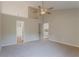 Another view of main bedroom featuring neutral carpet, ceiling fan, and ensuite bathroom at 4565 English Oaks Ln, Lilburn, GA 30047