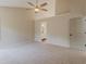 Large main bedroom with neutral carpet, ceiling fan, and an ensuite bathroom at 4565 English Oaks Ln, Lilburn, GA 30047