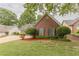 This property features a brick exterior, lush green lawn, and carefully manicured landscaping for great curb appeal at 4565 English Oaks Ln, Lilburn, GA 30047