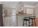 Open kitchen with granite counters, white cabinetry and stainless steel appliances at 4565 English Oaks Ln, Lilburn, GA 30047