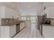 A bright kitchen boasts stainless appliances, tile backsplash, granite countertops, and white cabinetry at 4565 English Oaks Ln, Lilburn, GA 30047