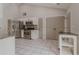 Open kitchen with stainless appliances, granite counters, tile floors and ample storage at 4565 English Oaks Ln, Lilburn, GA 30047