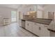 Updated kitchen features stainless steel appliances, granite counters, and white cabinets at 4565 English Oaks Ln, Lilburn, GA 30047