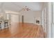 Bright open-concept living room with fireplace, hardwood floors and entry to outdoor space at 4565 English Oaks Ln, Lilburn, GA 30047